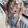 shortsleeved button down blouse with floral print