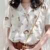 collared blouse with short sleeves and angel print